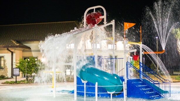 A water park with a water slide and a pool. - Rolling Skies Poolside Cinema Free BBQ Near Disney (Davenport)