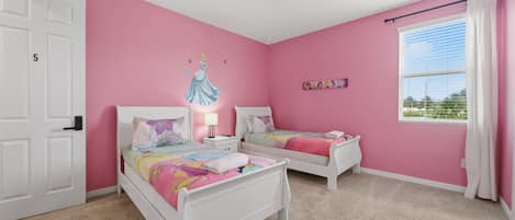 A bedroom with two white beds, a ceiling fan, a window with blinds, and a pink wall.