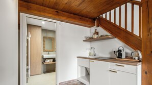 A kitchen with white cabinets, a wooden countertop, and a built-in stove. - Theava Collection -Citadelle- St Tropez (Saint-Tropez)