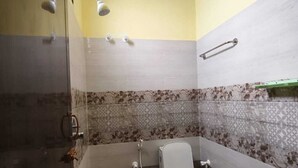 A bathroom with a shower, toilet, and bidet. - Pet friendly cozy 1 BH for couples/families/groups (Coimbatore)