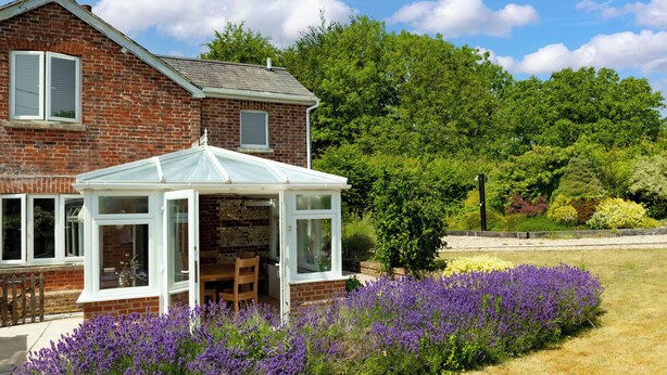 A two-story brick house with a conservatory. - Charming Countryside Cottage (Blandford Forum)
