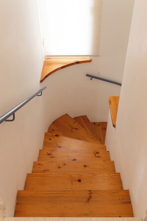 A wooden staircase with a handrail on one side and a window at the top. - Villa Nadezda – 3-Bedroom Villa with Pool near Paphos Harbour (Pafos)