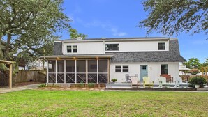 A two-story house with a covered patio area. - `The Harlow`- The Cottage Collection (Virginia Beach)