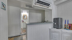 A kitchen with white cabinetry, a built-in stove, and a gray refrigerator. - Luna May - Charming 2 Bedroom, 3 Bath Beach House (Garden City Beach)