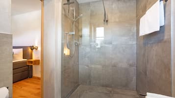 Ein modernes Badezimmer mit einer Glasdusche, einer Toilette und einem Waschbecken.