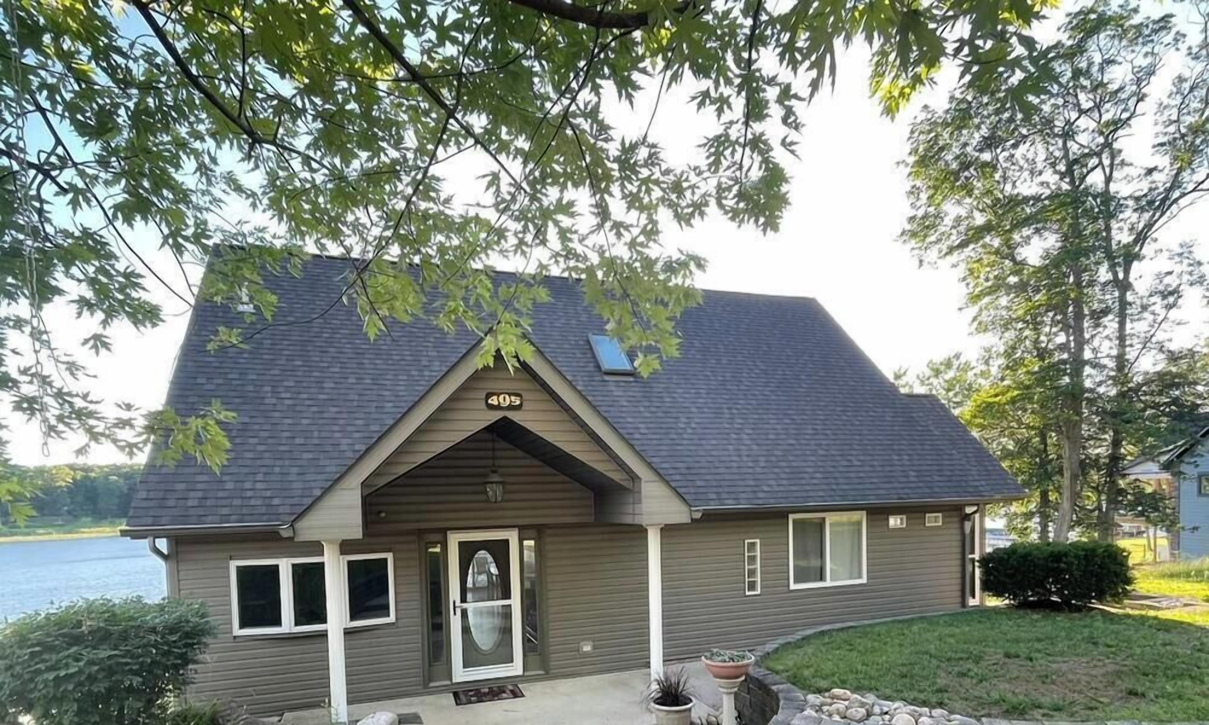 A single-story house with a gabled roof, a front door, and a small porch area.