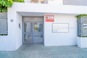 A gated entrance with a security sign, a mailbox, and a nameplate. - Cubo's Bel-Air Estepona Apartment / communal pool / parking included / air conditioning / free Wi-Fi (Estepona)