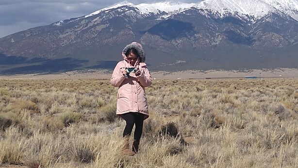 A person in a field with a mountain in the background. - 5 acre campground in Blanca perfect for outdoor getaways with picturesque view (Blanca)