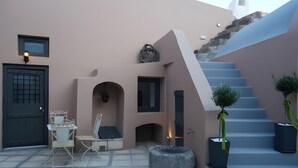 A modern building with a staircase, a door, and outdoor seating. - Apartment 'One-Bedroom' with Wi-Fi and Air Conditioning (Emporio)
