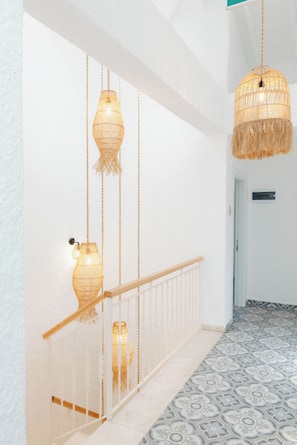 A staircase with a white railing and patterned floor tiles. - Pera Locale Alaçatı (Cesme)