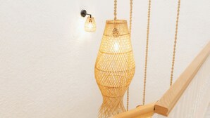 A staircase with a white railing and a hanging light fixture. - Pera Locale Alaçatı (Cesme)