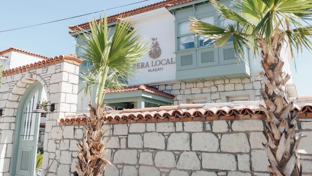 A building with a stone facade, a tiled roof, and a sign that reads 'PERA LOCAL ALAÇA'. - Pera Locale Alaçatı (Cesme)