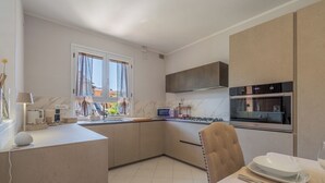 A modern kitchen with a built-in microwave, oven, and gas stove. - Casa Vellaria – Charming Home with Garden in Tuscany near Pisa & Florence (Forcoli)