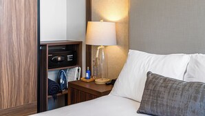 A hotel room with a bed, a nightstand, a lamp, a television, and a wardrobe. - Huge Private Terrace - Panoramic Bay Views - Walk to the Malecón (Puerto Vallarta)