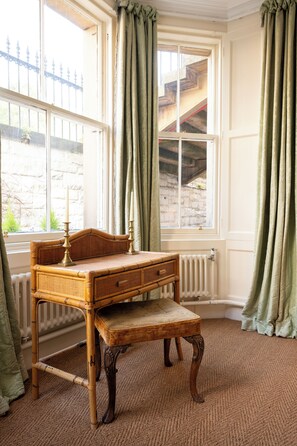 A room with a large window, a wooden writing desk, and a radiator. - Drumsheugh Garden House (Edinburgh)