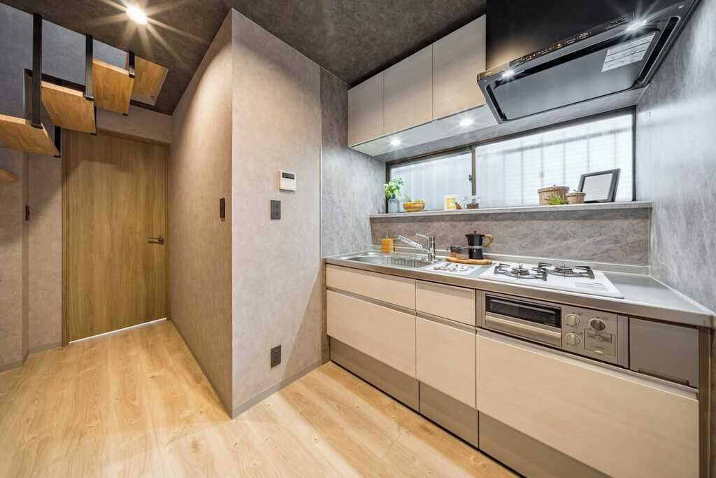 A modern kitchen with a built-in oven, a sink, and a stove.