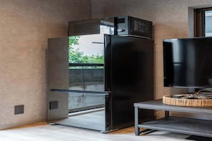 A modern kitchen with a built-in refrigerator and a flat-screen TV on a stand. - Designer-designed, accommodate 6 people / 8 minutes from Shinjuku and Shibuya. (Setagaya City)