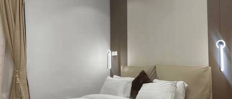 A modern bedroom with a bed, bedside tables, and a ceiling light fixture.