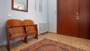 A room with a wooden wardrobe, a radiator, a patterned rug, and two wooden chairs. - Penthouse 4BR Apartment · Terrace · Bosphorus View · Central Beyoğlu (Beyoğlu)