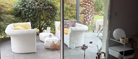 A modern interior with a sliding glass door leading to an outdoor patio area.