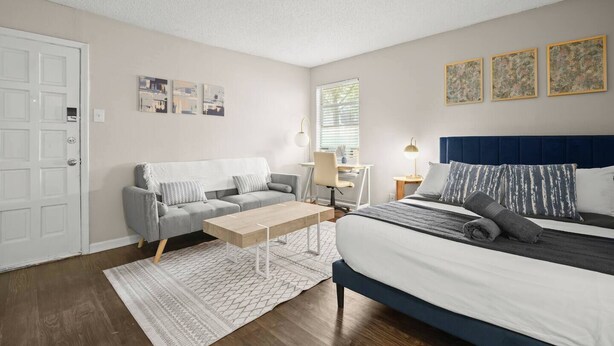 A bedroom with a bed, a sofa, a desk, and a chair. - Zilker Park Studio | Near Barton Springs &Downtown (Austin)