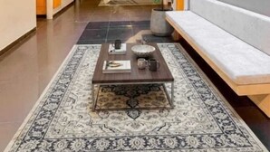 A modern interior with a staircase, a seating area, and a coffee table. - Hotel Centro (Cali)