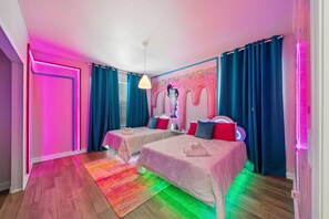 A hotel room with two beds, a colorful wall mural, and a modern pendant light. - Brand New 5BR 5BA Villa w Pool  Spa   Game Room 7800 (Kissimmee)