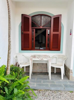 A room with a window, a table, and two chairs.