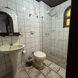 A bathroom with a sink, toilet, and shower.