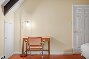A room with a wooden desk, a chair, a lamp, and a door. - A-Frame Retreat - Hot Tub, Fire Pit & Fireplace (Monroe County)