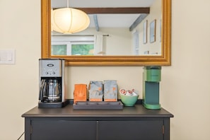 A kitchenette with a coffee maker, a Keurig, and coffee pods on a counter. - A-Frame Retreat - Hot Tub, Fire Pit & Fireplace (Monroe County)