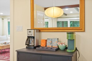 A coffee station with a coffee maker, a Keurig, and coffee pods on a counter. - A-Frame Retreat - Hot Tub, Fire Pit & Fireplace (Monroe County)
