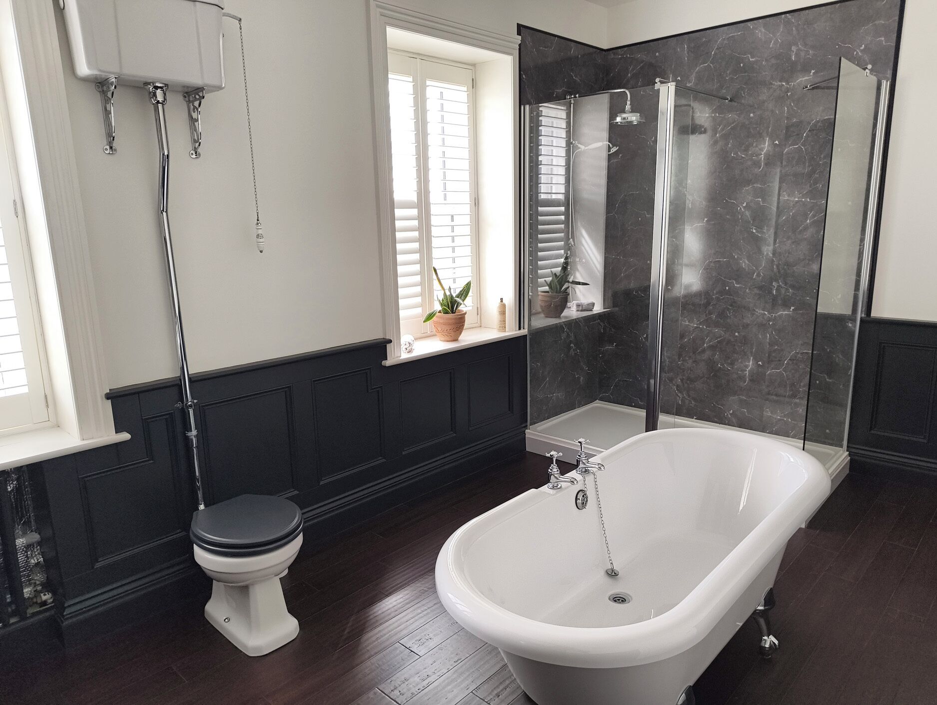A bathroom with a freestanding bathtub, a toilet, and a shower enclosure.