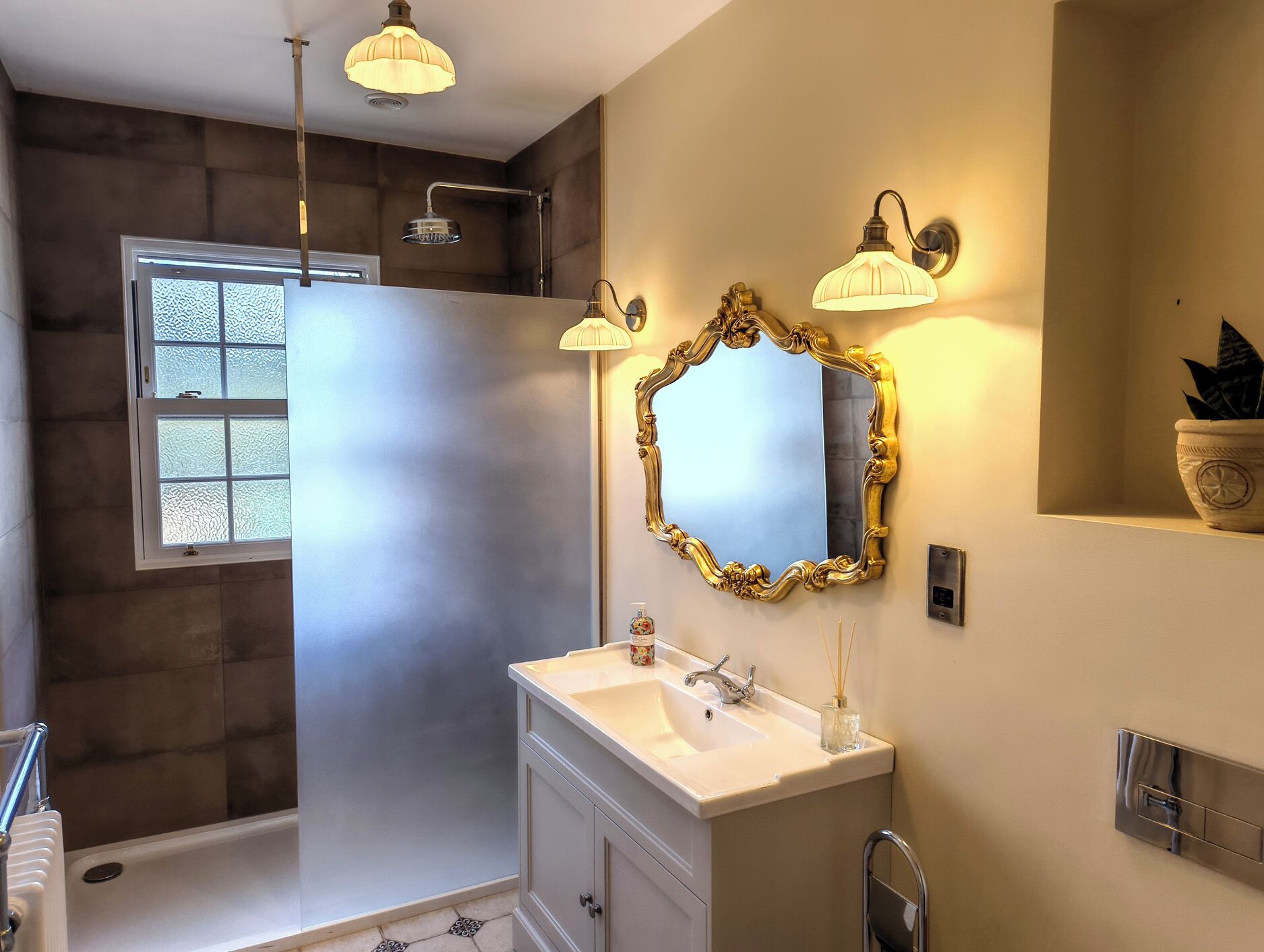 A modern bathroom with a shower, vanity, and a large mirror.