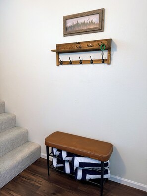 A wooden coat rack with hooks, a bench with towels, and a framed picture on the wall. - Quiet Birch Bay Escape | Walk to Beach & Fun (Blaine)