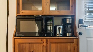 A kitchen with a microwave, toaster, and coffee maker on a wooden cabinet. - 
Spacious 4BR Townhouse  Sleeps 13  Near DC&Metro (Arlington)