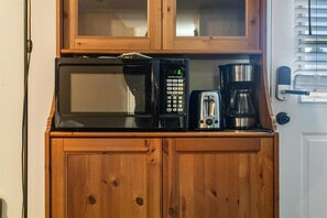 A kitchen with a microwave, toaster, and coffee maker on a wooden cabinet. - 
Spacious 4BR Townhouse  Sleeps 13  Near DC&Metro (Arlington)
