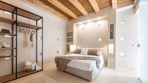 A bedroom with a bed, bedside tables, a wardrobe, and a mirror. - Ultra-Lux Tower Villa: Dual Pools, Near Beaches (Gallipoli)