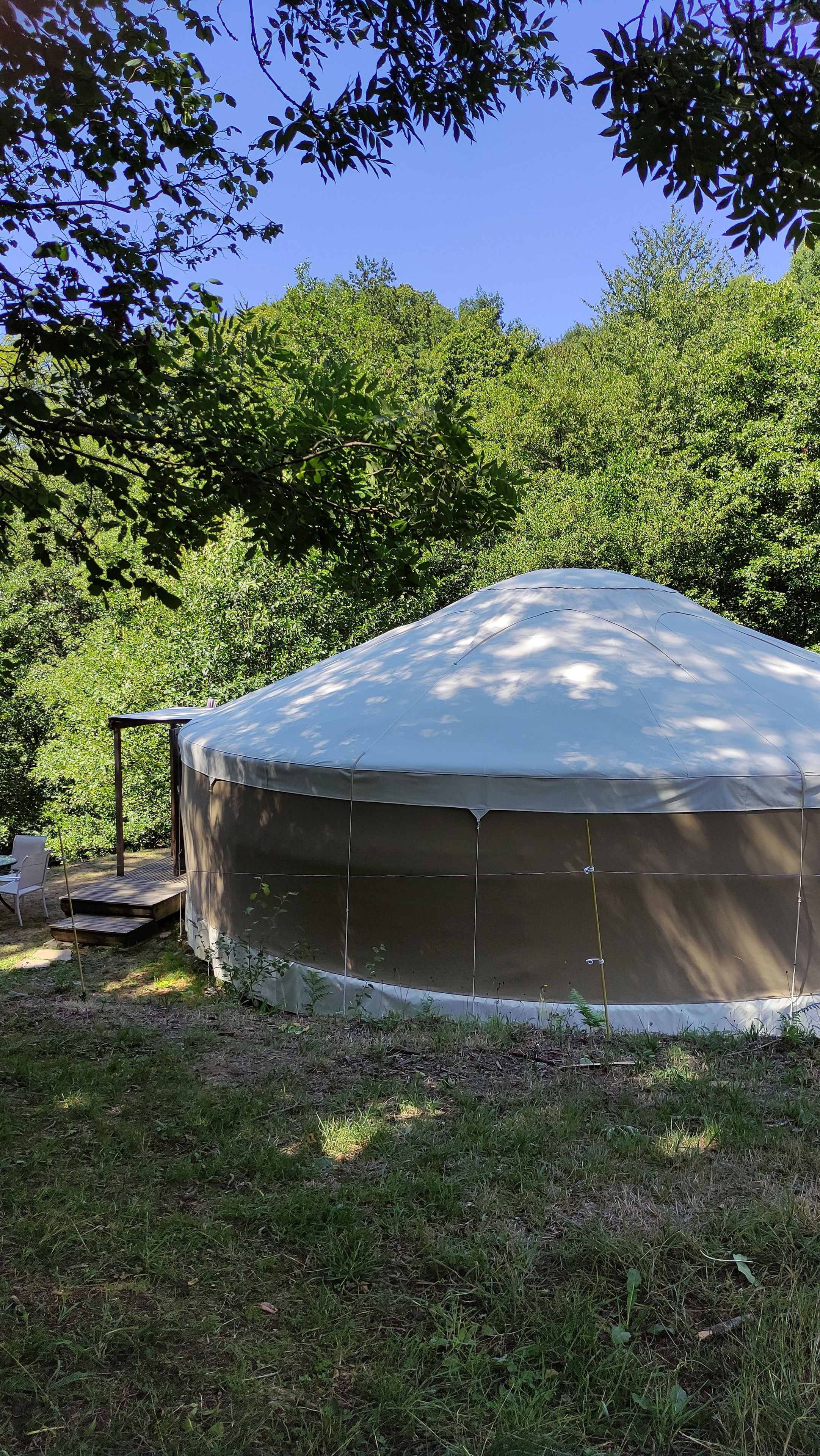 A large, covered outdoor structure, possibly a tent or gazebo, with a metal frame and a roof.