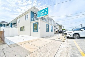 A two-story building with a sign that reads 'SALTY SHORE.' - Seaside Serenity: Salty Shore Retreat (Wildwood)