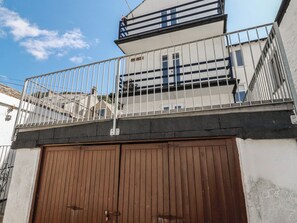 A gated entrance with a metal fence and a brown garage door. - Harbourside Retreat (Looe)