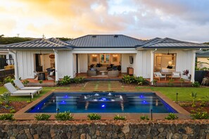 A two-story house with a swimming pool, outdoor seating, and a well-maintained garden. - Makani Kai by Gather: Brand-New Luxury Home w/ Private Pool & Spa, AC, Chef’ (Koloa)