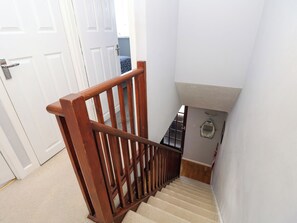 A wooden staircase with a handrail leading to a landing. - 73 Pennywell Gardens (New Milton)