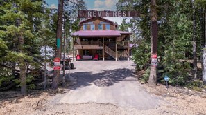 A cabin with a porch and a sign reading 'REV & REST' at the entrance. - Rev & Rest Lodge Duck Creek (Duck Creek Village)