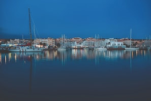 A marina with multiple boats docked, surrounded by buildings with balconies. - Deluxe 2-Bedroom Apartment (El Ejido)