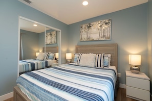 A bedroom with two beds, a large mirror, and artwork on the wall. - 3BR Chula Vista Getaway Near Gaylord Pacific (Chula Vista)