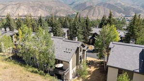 A residential area with multiple houses, each featuring a sloped roof and surrounded by trees. - Ridgepoint Townhome 166 - 4 Bedroom Residence (Beaver Creek)