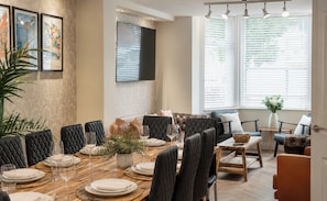 A dining area with a wooden table set for six, surrounded by upholstered chairs. - 125 Columbus Ravine (Scarborough)