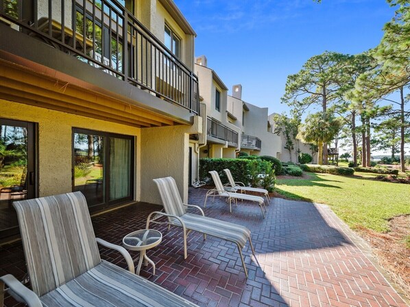 A hotel with a patio area featuring outdoor seating and a view of the surrounding landscape.
