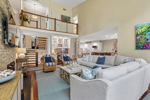 A spacious living room with a high ceiling, a dining area, and a kitchen. - Gorgeous Villa w/ Panoramic Views (Hilton Head Island)